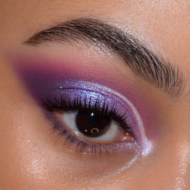 All Amethyst ColourPop Shadow Palette creating a shimmering lilac cut-crease with plum and lavender mattes on a close-up eye, inner-corner sparkle and defined lashes showcasing high pigment, blendability, and multidimensional sheen.