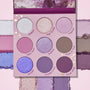 ColourPop All Amethyst shadow palette displays a 9-pan array of purple-toned shades - icy silver, lilac shimmers, taupe, and matte plums - with swatches framing the compact on a pink backdrop and an amethyst-print lid.