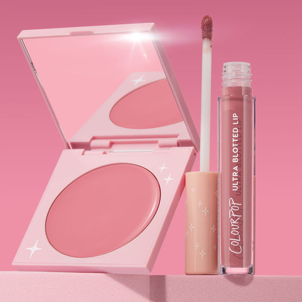 That’s So Rosy ColourPop Cheek & Lip Set showing an open rosy-pink blush compact and Ultra Blotted Lip in a mauve rose, wand uncapped, on a pink backdrop with star-accent packaging and a mirrored lid catching light.