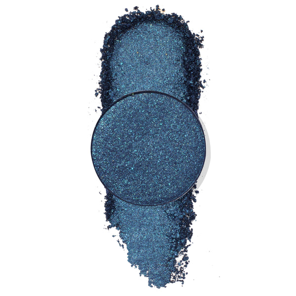 Antimatter pressed powder eyeshadow - deep navy‑teal metallic with aqua microglitter - shown as a round single pan over a crushed vertical swatch on a white backdrop; ColourPop Pressed Powder Shadow single for bold, shimmering eye looks.