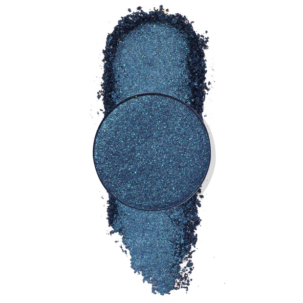 Antimatter pressed powder eyeshadow - deep navy‑teal metallic with aqua microglitter - shown as a round single pan over a crushed vertical swatch on a white backdrop; ColourPop Pressed Powder Shadow single for bold, shimmering eye looks.