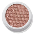 Aster ColourPop Super Shock Shadow sparkles in a close-up of its shimmery rose-gold single eyeshadow pan, embossed with a quilted texture inside a white round pot, studio-lit against a clean white background.