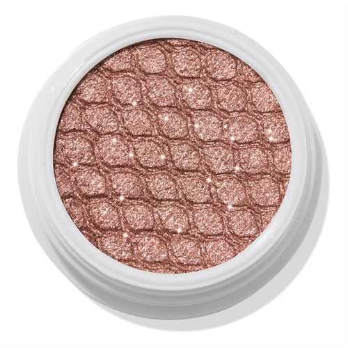 Aster ColourPop Super Shock Shadow sparkles in a close-up of its shimmery rose-gold single eyeshadow pan, embossed with a quilted texture inside a white round pot, studio-lit against a clean white background.