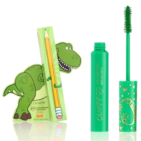 ColourPop BFF Mascara Roar! displays an open green volumizing mascara tube with wand coated in green, set beside a Toy Story Rex–illustrated box and star-patterned cap, product standing upright against a clean white background.