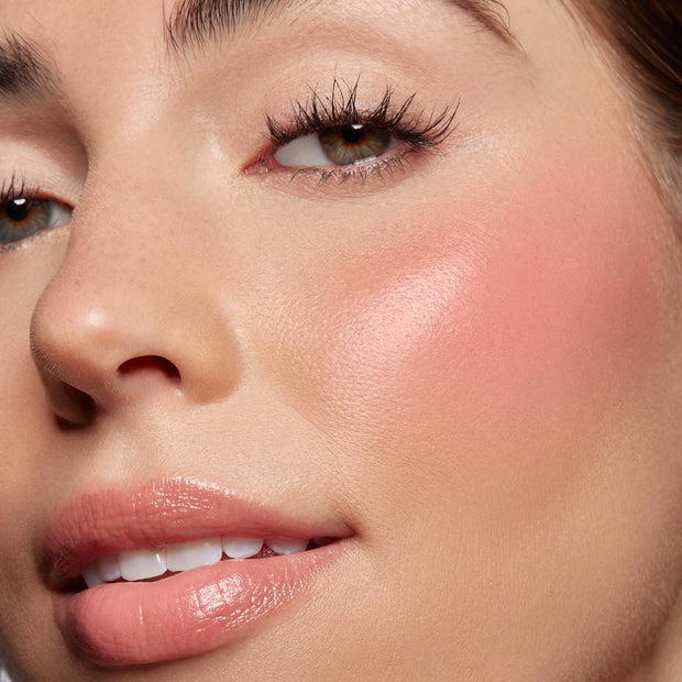 Baby Bunny, a ColourPop Lip and Cheek Balm, softens a model’s cheeks with a dewy rosy flush and adds sheer pink shine to lips; extreme close-up highlights smooth, hydrated skin, natural glow, and a buildable glossy finish.
