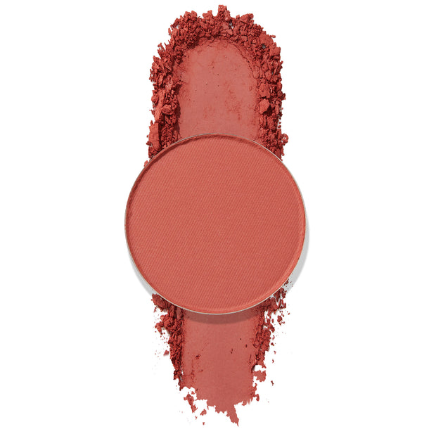 Balancing Act pressed powder shadow pan spills crushed warm terracotta pigment on a white background, highlighting a matte finish; ColourPop Pressed Powder Shadow single pan for buildable eye color.