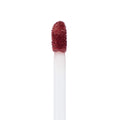 Doe-foot applicator coated in Beeper, a brown‑mauve ColourPop Ultra Matte Lip, showing dense velvety pigment on the sponge tip in a macro close-up against a white background, emphasizing precise, full‑coverage liquid lipstick.