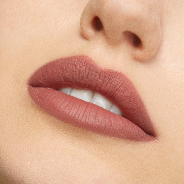 Lips wearing Beeper, a ColourPop Lippie Pencil, lining and filling the mouth in a soft matte neutral mauve-brown, shown in a close-up beauty shot to highlight crisp edges and full coverage.