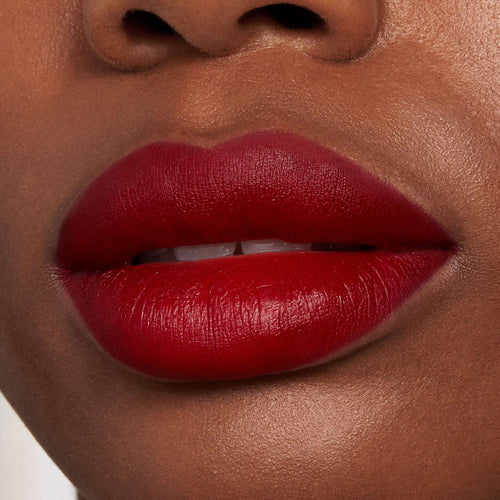 Bold lips wearing Bichette, precisely lined with ColourPop Lippie Pencil, showcasing a rich deep red and smooth, creamy matte finish in a tight studio close-up beauty shot.