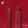 ColourPop Lippie Pencil in Bichette stands uncapped beside the matching Lippie Stix on a glossy deep red swatch background with sparkle accents and a heart-shaped ColourPop logo, showcasing its rich wine-red shade and precise tip.