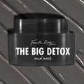 Black Fourth Ray Beauty The Big Detox Mud Mask jar displayed in a close-up flat lay, the ColourPop Face Mask resting on swirled charcoal mud with white streaks, showcasing the sleek container and bold white logo for detoxifying skincare.