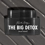 Black Fourth Ray Beauty The Big Detox Mud Mask jar displayed in a close-up flat lay, the ColourPop Face Mask resting on swirled charcoal mud with white streaks, showcasing the sleek container and bold white logo for detoxifying skincare.
