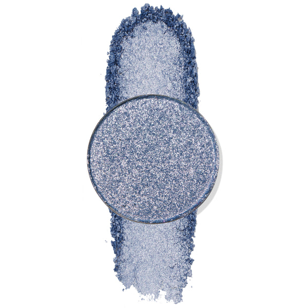 Billie Jean ColourPop Pressed Powder Shadow pan displays a metallic denim-blue shade with silver sparkle, set atop a crushed vertical swatch to show pigment and shimmer payoff on a white background.