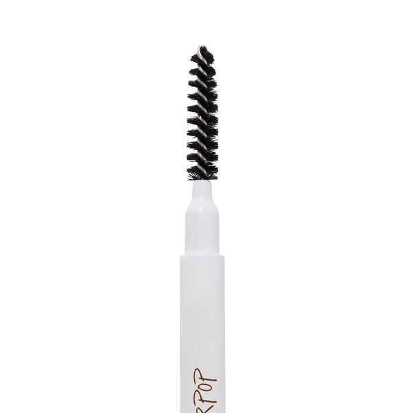 ColourPop Black N' Brown Pencil brow pencil spoolie brushing and shaping eyebrows, close-up of black spiral bristles on a white barrel with partial logo, isolated on a white background.