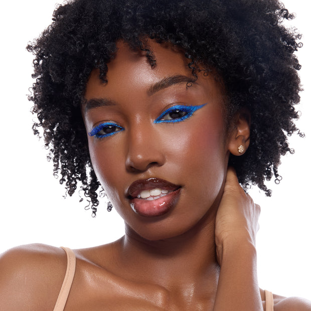 Blue Moon shadow palette by ColourPop creating a bold cobalt blue winged eye look on a close-up model, showcasing the intense pigment of this ColourPop Shadow Palette against a clean white studio background.