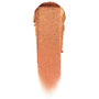 Brentwood ColourPop Jelly Much Shadow swatch, a metallic copper-bronze gel eyeshadow smear with gold shimmer, fanned to a soft fade on a white background, showcasing the Jelly Much Shadow texture and reflective finish.