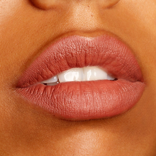 Lips wear Brink, a ColourPop Lippie Pencil, defining and filling the mouth in a warm rosy terracotta nude with a soft matte finish, shown in a close-up beauty swatch to highlight the creamy, long-wearing precision of this lip liner.