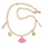Gold charm necklace with oval links displays dangling pink ColourPop lips charm, mini “So Juicy” lip tube, bunny, strawberry, and pink enamel tag, laid on white; part of the Charmed and Juicy ColourPop So Juicy Lip Oil and Necklace Set.