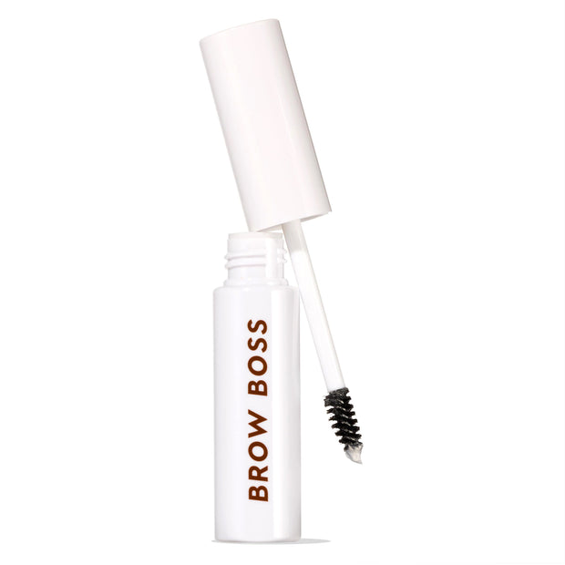 White Brow Boss Gel Clear tube with open cap and spoolie wand angled out, showing translucent formula for shaping and setting eyebrows, isolated on white background for brow makeup product display.