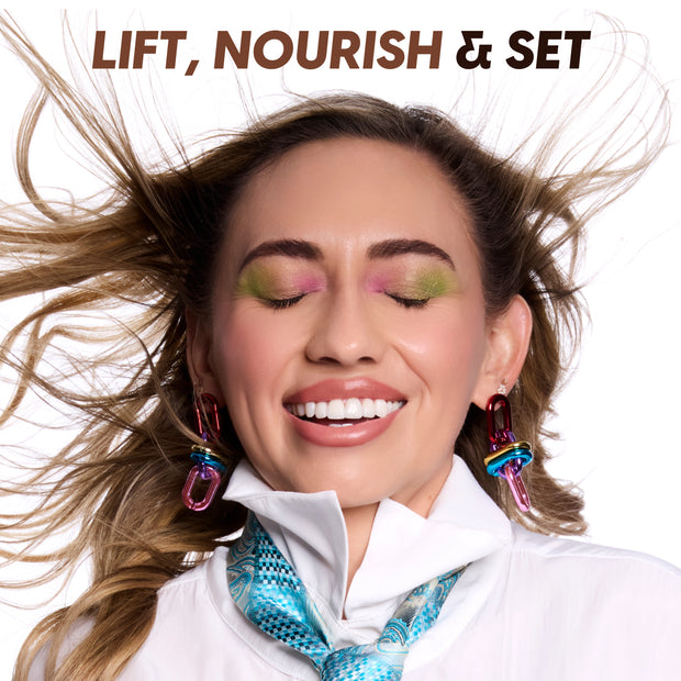Smiling woman with windblown hair shows softly defined brows using Clear Brow Boss Gel, wearing bright green and pink eyeshadow and glossy lips, under bold text “LIFT, NOURISH & SET,” promoting natural brow makeup results.