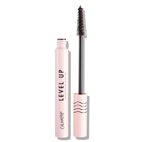 ColourPop Level Up Lengthening Mascara in Brown, open with slim wand lifted and bristles coated, standing beside a pale pink tube labeled LEVEL UP with wavy-line cap, shown on a clean white background.