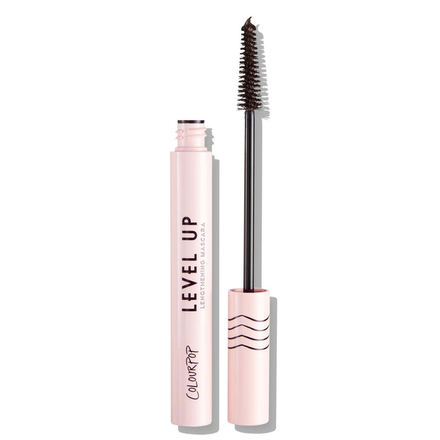 ColourPop Level Up Lengthening Mascara in Brown, open with slim wand lifted and bristles coated, standing beside a pale pink tube labeled LEVEL UP with wavy-line cap, shown on a clean white background.