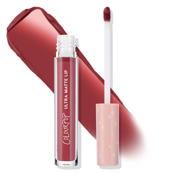 ColourPop Bumble Ultra Matte Lip liquid lipstick stands open with doe-foot applicator beside it, revealing a warm rosy mauve swatch; clear tube labeled Ultra Matte Lip, pink cap with star accents, studio white backdrop.
