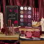 ColourPop Full Collection Set featuring A Shadow of Secrets Collection displayed on vintage books: 12‑pan plum‑toned shimmer eyeshadow palette, So Juicy glosses, lipsticks and liners, cream shadow pots, and heart‑shaped blushes amid candles and burgundy velvet.