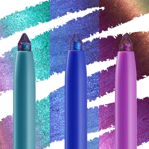 Chrome Dreams ColourPop Chrome Crème Gel Liner trio standing upright; teal, cobalt, and pink barrels with multichrome tips, set before bold swatches shifting from teal to lilac, blue to violet, and magenta to gold in a studio close-up.