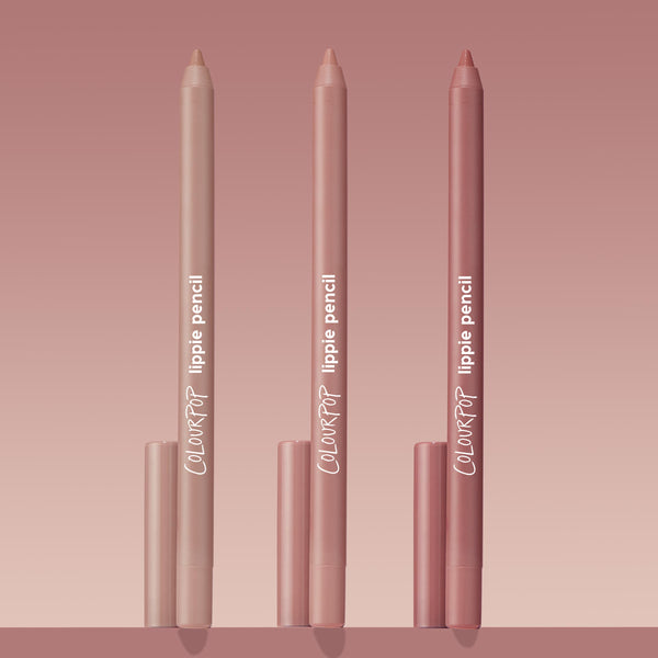 Trio of ColourPop Lippie Pencil Cool Besties standing upright, tips exposed, in light nude, pink nude, and rosy mauve tones with matching caps, arranged on a blush gradient background for a clean product shot.