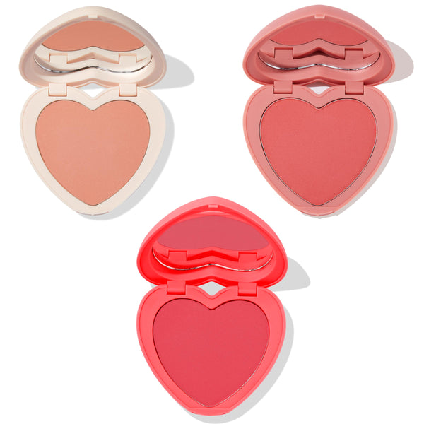 Current Crush heart powder blush set displaying three open heart-shaped compacts with mirrors - peach nude in ivory case, warm rose in pink, and bright coral-red in red - ColourPop Heart Powder Blush Set on a clean white background.