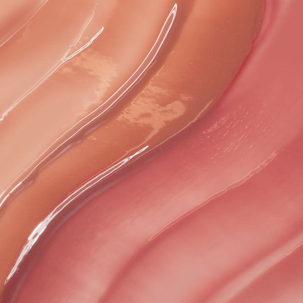 Multi-shade lip oil swatches in peach and rose hues gliding in glossy waves, showcasing the high-shine, sheer finish of Juicy Moment, a ColourPop So Juicy Lip Oil Set.