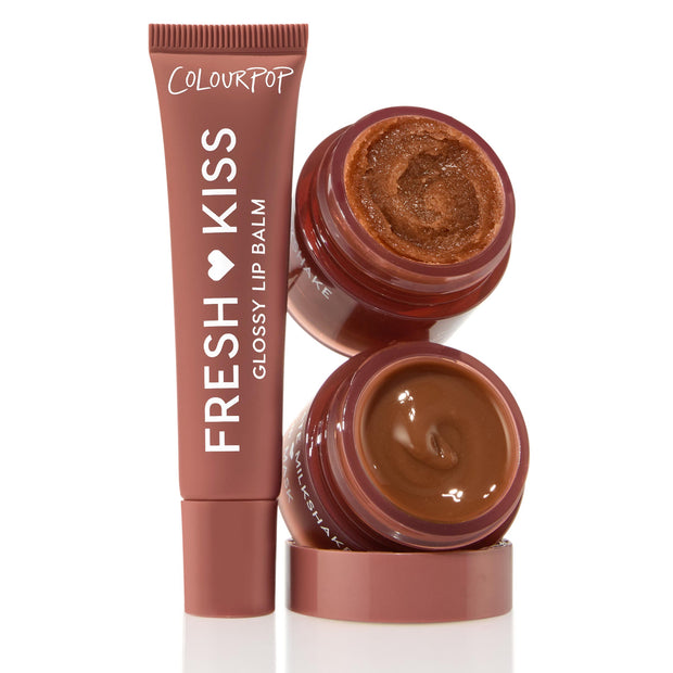 Triple Chocolate ColourPop Lip Care Kit featuring a Fresh Kiss Glossy Lip Balm tube standing beside two open chocolate-brown pots - one grainy scrub, one creamy treatment - stacked to showcase texture and rich cocoa shade on a white background.