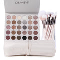 The Ultimate Stunner ColourPop Shadow Palette & Brush Set displaying an open 30‑pan neutral matte and shimmer eyeshadow palette beside pink‑handled makeup brushes in a clear cup and a cream brush roll, on a white background.