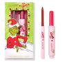 Berry Grinchy So Juicy Plumping Gloss Stick by ColourPop shown with matching lip liner, both in pink tubes, set beside a green ColourPop x The Grinch holiday box featuring the Grinch; berry shade bullet and liner tip visible.