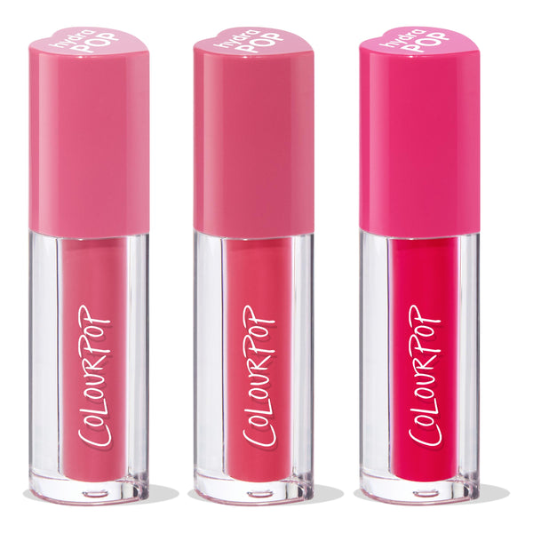 ColourPop Lip Stain Tickle Me Pink trio standing upright, each clear tube with white ColourPop logo and heart-shaped pink caps, showcasing soft rose, medium pink, and bold fuchsia shades on a white studio background.