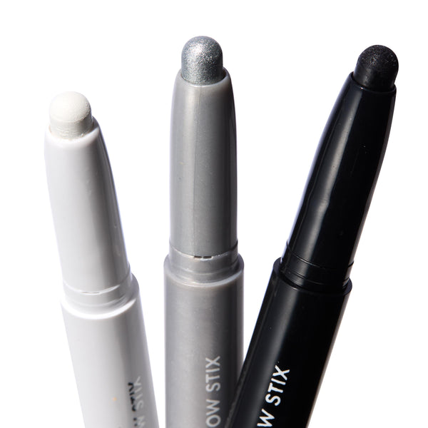 Totally Wicked ColourPop Shadow Stix trio showing exposed tips - matte white, metallic silver, and black shimmer - standing upright in white, gray, and black twist-up tubes on a bright white background.