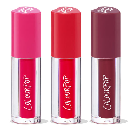 Very Berry ColourPop Lip Stain trio standing upright, showcasing bold berry shades - fuchsia, cherry red, and deep plum - in clear tubes with ColourPop logo and heart-shaped caps, lined up on a white background.