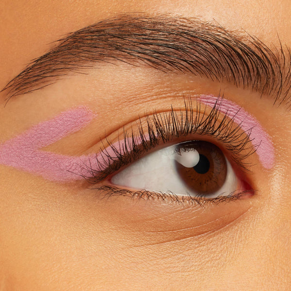 Amethyst Hour ColourPop Crème Gel Liner sweeping in pastel lavender graphic strokes along the upper lid and crease, accenting a brown eye with natural lashes on smooth skin, showcasing the creamy Crème Gel Liner texture.