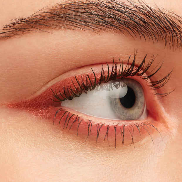 Eye showcasing Get Lucid, a metallic copper‑pink ColourPop Crème Gel Liner, swept along upper and lower lash lines with a soft inner-corner flick, emphasizing defined lashes in a clean close-up beauty shot.