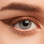 Metallic copper winged eyeliner on a gray-blue eye, showcasing Overboard, a ColourPop Crème Gel Liner; creamy bronze line sweeps across the upper lash line and extends to a soft flick, with a subtle lid smudge in a close-up beauty swatch.