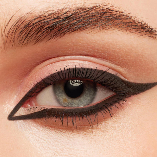 New BFF Crème Gel Liner tracing a bold, matte black graphic cat eye around a blue‑gray iris, with a precise inner corner point and extended wing, shown in a close-up of natural lashes and groomed brow; ColourPop TTS Exclusive.