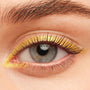 Eye lined with Toucan Do It metallic gold ColourPop Crème Gel Liner, creating a sharp graphic wing and inner-corner flick along the upper and lower lash lines, framed by natural lashes and brow.
