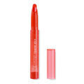ColourPop Lippie Stix in Chi Chi stands uncapped with its slanted orange-red bullet exposed, the translucent coral tube shows COLOURPOP lippie stix branding, while the cap rests beside it on a white background.