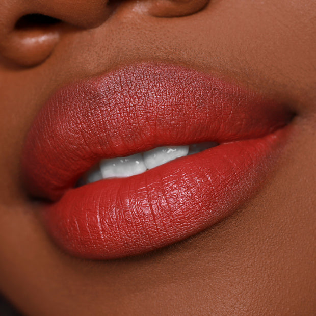 Full lips wearing Bumble ColourPop Lippie Pencil, a warm terracotta red lip liner used to define and fill for a smooth, creamy finish, shown in an extreme close-up beauty shot.