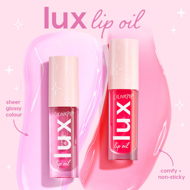 ColourPop Lux Lip Oil in Cherry Bite stands upright with a clear tube and blush cap, showing a bright cherry-red tint; glossy swatches behind highlight sheer, comfy, non-sticky shine on a pink backdrop alongside a second pink shade.