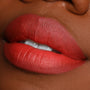 Matte, terracotta-red lips showcasing the Love Bug shade, lined and filled with the ColourPop Lippie Pencil, captured in a tight studio close-up to highlight smooth texture and precise edges for this Lippie Pencil product.