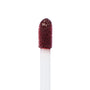 Doe-foot applicator coated in ColourPop Ultra Blotted Lip Canon Dr, a deep berry shade, captured in a macro close-up with saturated pigment on the fuzzy tip against a clean white background.