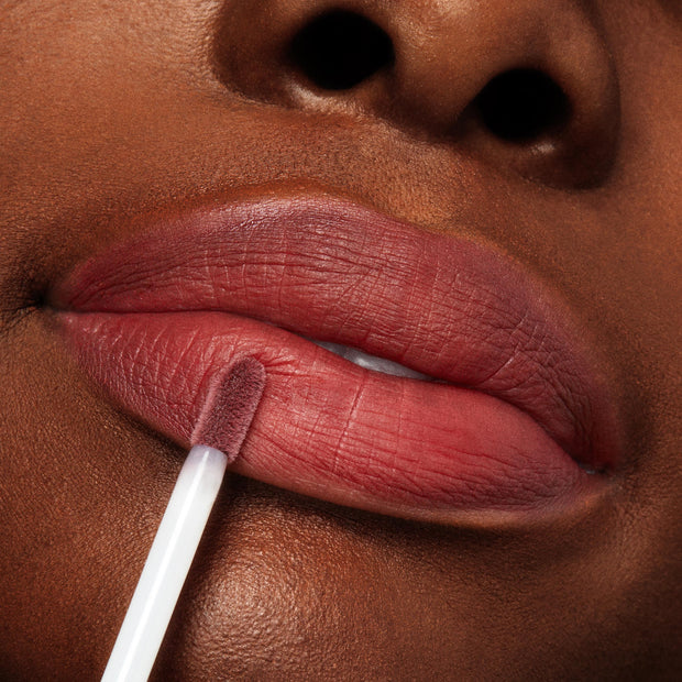 Doe-foot applicator glides a rosy-mauve stain onto lips, showcasing the creamy, blendable finish of Blush n' Pout, a ColourPop Cheek & Lip Set, in a tight beauty close-up for effortless lip-and-cheek color.