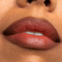 ColourPop Chain Reaction Lippie Pencil defining and filling lips in a warm terracotta-brown shade with a soft sheen, shown in an extreme close-up beauty swatch for precise lip lining and all-over color.